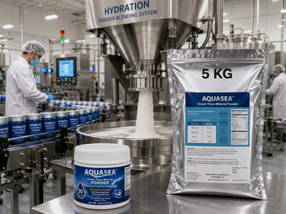 AQUASEA™ Ocean Trace Mineral Powder 5 kg bag and 1.48 oz evaluation sample in a commercial hydration powder manufacturing facility with stainless steel blending equipment and electrolyte drink mix packaging line.