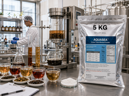 AQUASEA™ Ocean Trace Mineral Powder 5 kg bulk ingredient bag used in commercial tea product development and beverage formulation laboratory with botanical ingredients and precision brewing equipment.